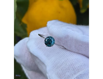 18CT WHITE GOLD VIVID TEAL BLUE DIAMOND RING – 0.9...