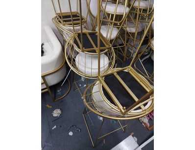 Set of stackable bistro chairs featuring brass-ton...