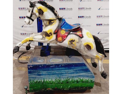 Vintage coin-operated carousel horse kiddie ride.
...