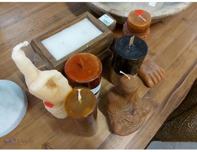 collection of decorative candles and wooden sculpt...