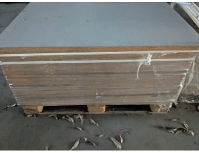Pallet of gypsum plasterboard sheets wrapped in pl...