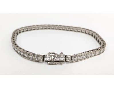 Sterling silver tennis bracelet featuring a contin...
