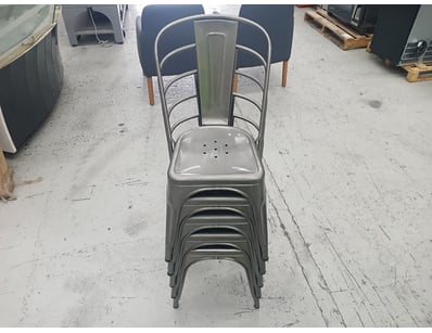 Industrial-style metal dining chairs featuring gal...