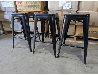 Set of three industrial-style bar stools featuring...