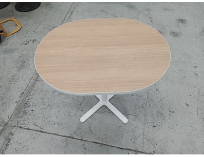 Modern pedestal dining table featuring an oval lig...