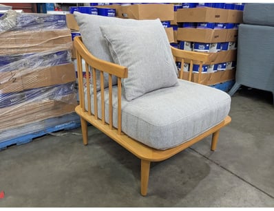 Modern armchair featuring a natural timber frame w...