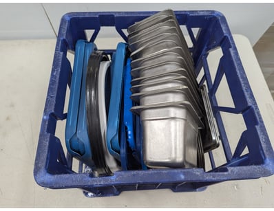 Blue plastic crate containing a comprehensive coll...