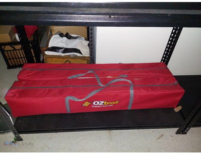 Oztrail Instant Canopy in red storage bag. The can...