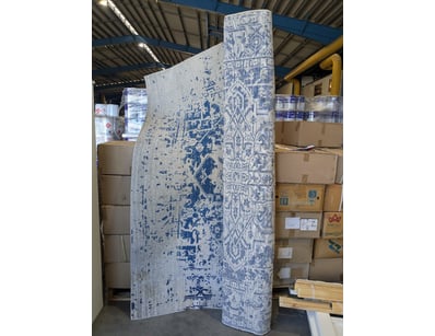 Blue and cream rug featuring traditional geometric...