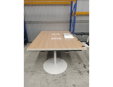 Modern conference table featuring a light oak wood...