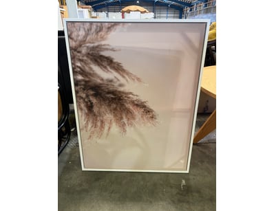 White framed wall art featuring a minimalist botan...
