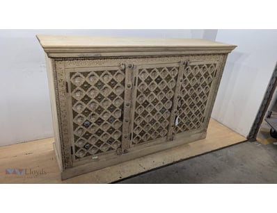 Whitewashed timber sideboard featuring three carve...