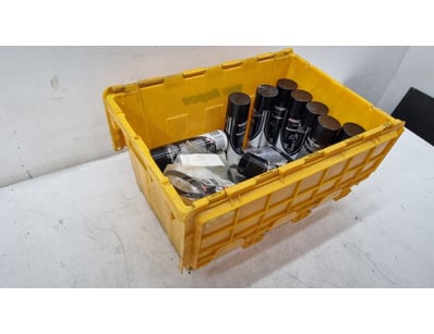 Yellow plastic storage crate containing automotive...