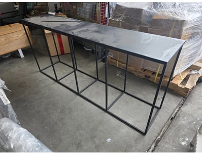 Industrial-style console table featuring a minimal...
