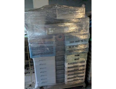 Large collection of plastic storage crates and bas...