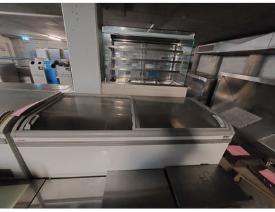 Commercial chest freezer featuring curved glass sl...