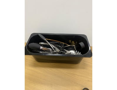 Mix of cafe/kitchen utensils. Tongs and spoons. 
...
