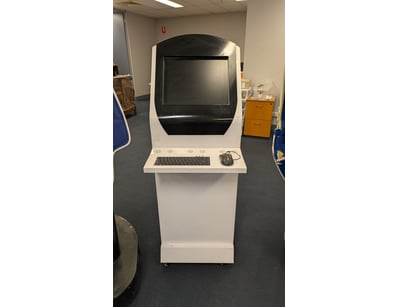 Vintage arcade kiosk cabinet featuring a curved wh...