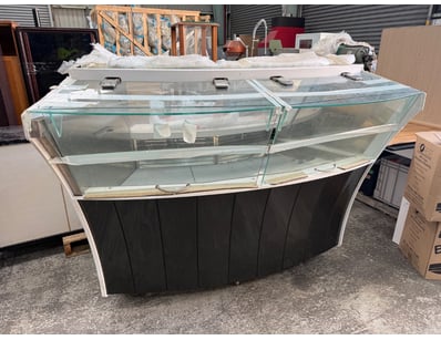 Commercial curved glass display counter featuring ...