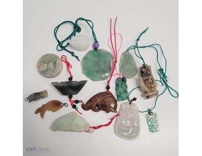 COLLECTION OF ASIAN JADE AND STONE CARVED PENDANTS...