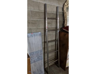 Polished chrome towel ladder featuring a sleek, mo...