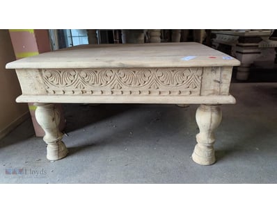 Timber coffee table featuring hand-carved decorati...