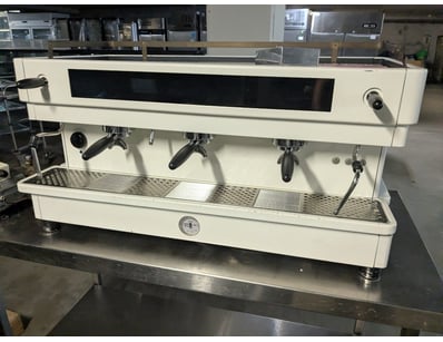 Commercial espresso coffee machine featuring three...