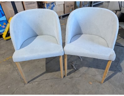 Pair of dining chairs featuring curved, barrel-bac...