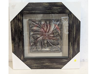 Framed relief artwork featuring an ornamental flor...