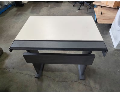 Modern dining table featuring a white laminate top...