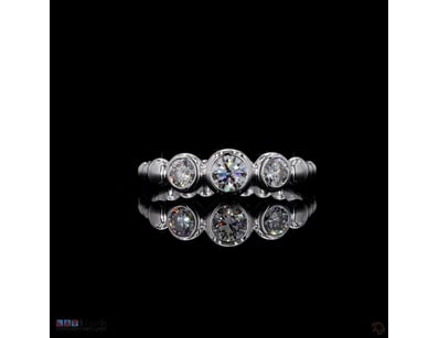 0.76 CT ROUND THREE-STONE BEZEL BAND IN 18KT WHITE...