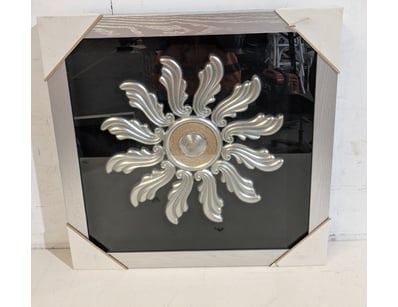 Ornamental sunburst wall medallion featuring class...
