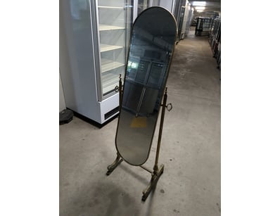 Vintage like brass cheval mirror featuring an orna...