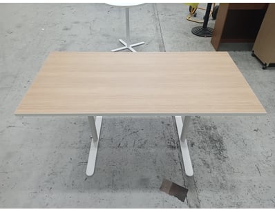Modern dining table featuring a light oak laminate...