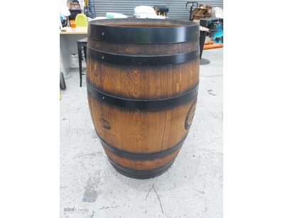Authentic wooden barrel with black steel hoops and...