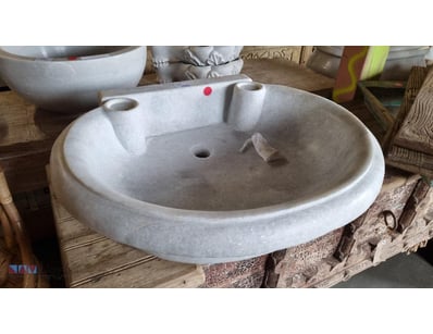 Elegant Stone basin featuring a classic round desi...