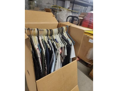 Bulk lot of assorted women's clothing on hangers, ...
