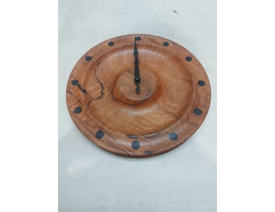 Handcrafted wooden wall clock featuring a round ti...