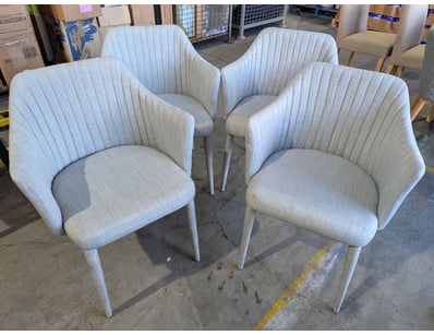 Set of four dining chairs featuring light grey uph...