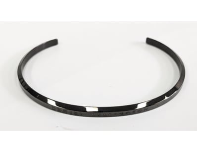 Daniel Wellington cuff bangle featuring a polished...