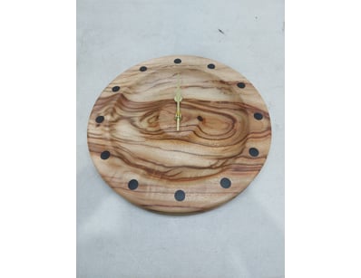 Handcrafted wooden wall clock featuring a striking...