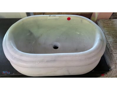 cream/white stone decorative basin featuring organ...