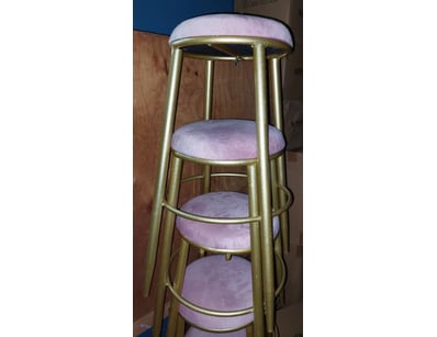 Set of four nesting bar stools featuring brass-fin...