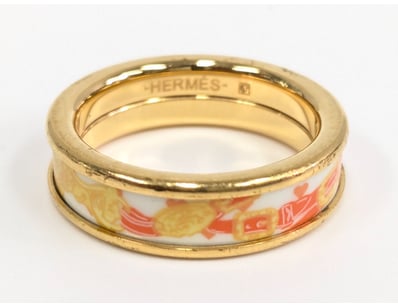 Hermès gold-plated bangle bracelet featuring a dec...