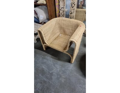 Natural woven rattan chair featuring a curved, org...