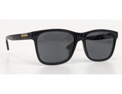 Gucci black acetate sunglasses featuring dark grey...