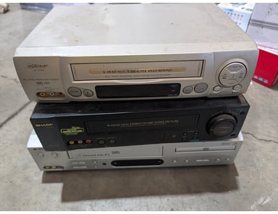 Media Player Lot with Various VHS Player Models In...
