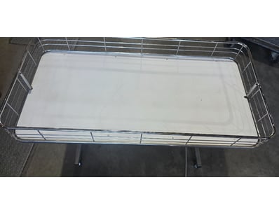 Metal framed tub on wheels.