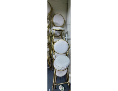 Set of stackable dining chairs featuring brass-ton...
