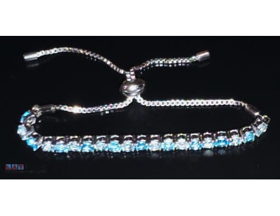 46 TCW SILVER AND TOPAZ TENNIS BRACELET.        

...